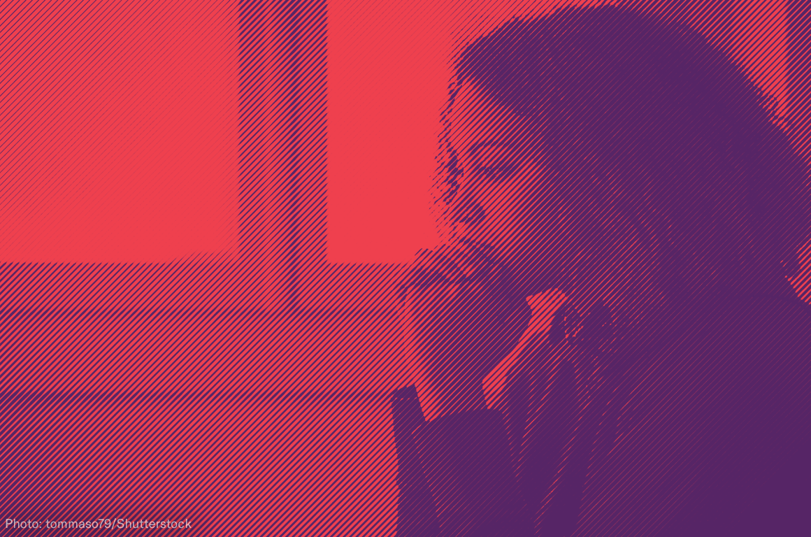 Woman with hands clasped in front of her