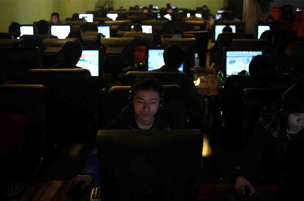 People use computers at an Internet cafe in Chengdu in southwest China's Sichuan province