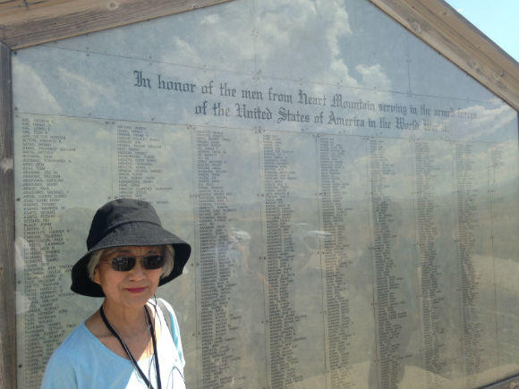  My mother in front of the list of men — including both her brothers — who were incarcerated at Heart Mountain and served in the U.S. armed forces in World War II.