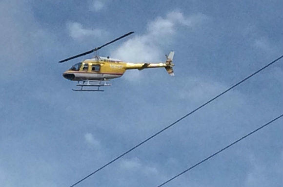 Private contractor helicopter flies over water protector vehicles as they drove along public county roads in North Dakota on October 4.