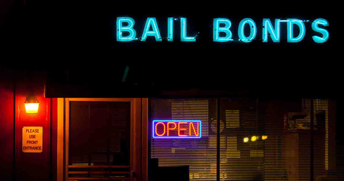 Neon bail bonds sign outside building