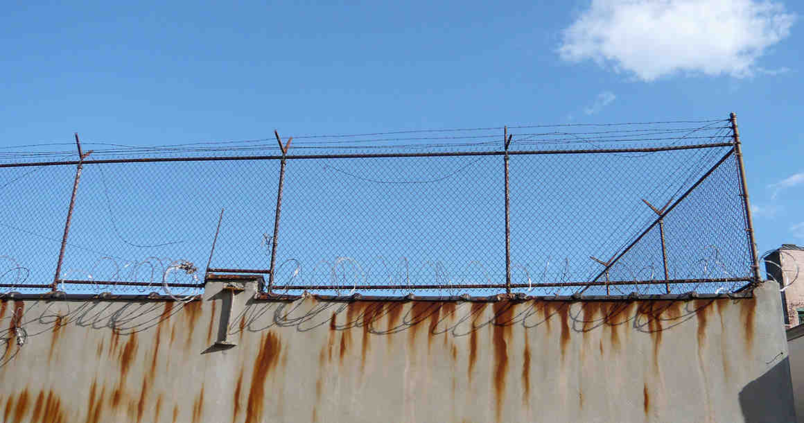 Barbed wire fence outside prison
