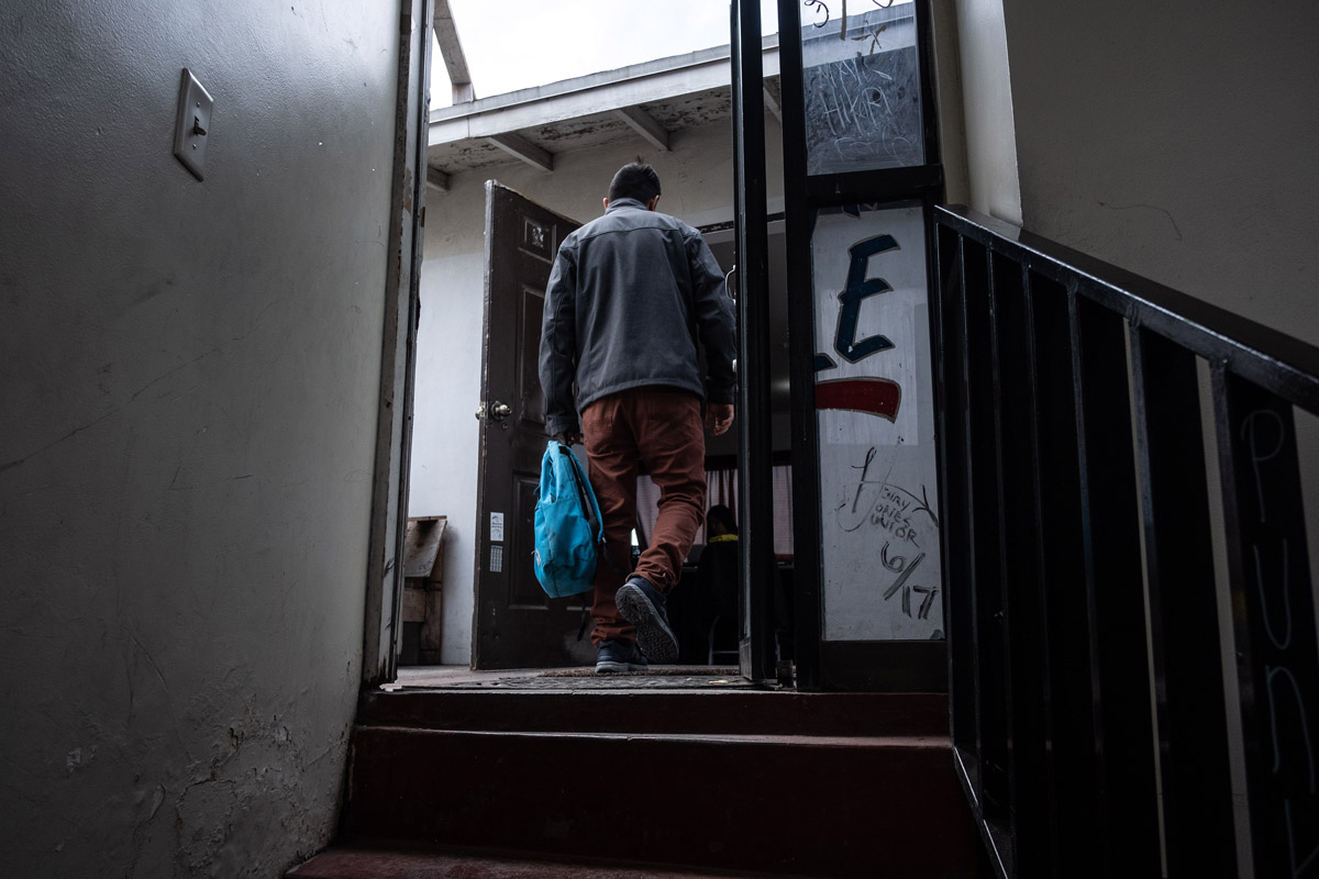 Asylum seeker walks into the house where he sleeps in Tijuana.