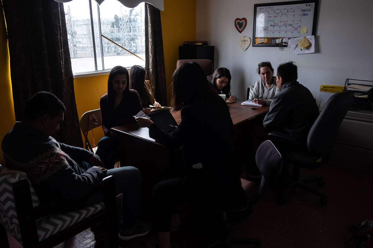 Asylum seekers and legal team meet at a community center in Tijuana.