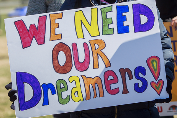 Defend Our Immigrant Families Rally with supporters holding posters