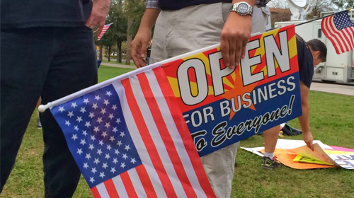 Protest sign and american flag