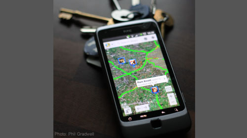 Image of a cell-phone displaying location information on a map.