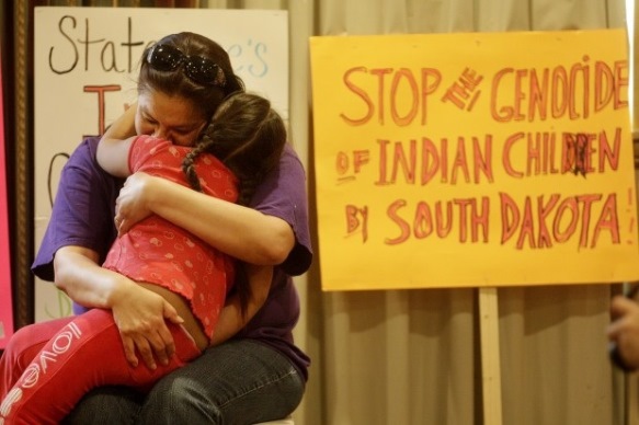 ACLU client Madonna Pappan hugs her daughter Charlotte.