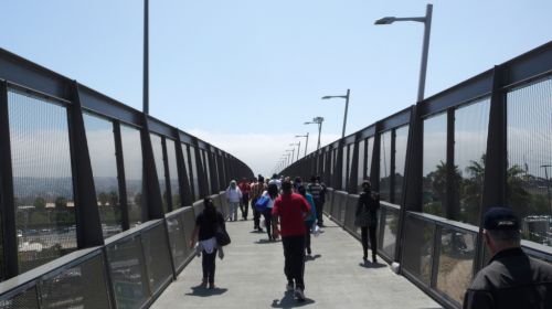 People walking over a bridge.