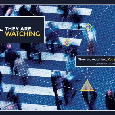 "They Are Watching" promo image showing street surveillance