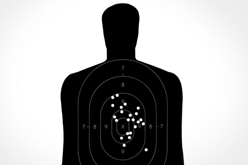 Person-shaped target with bullet holes