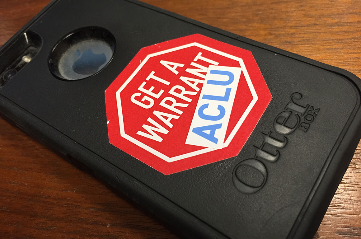 iPhone with "Get a Warrant - ACLU" sticker