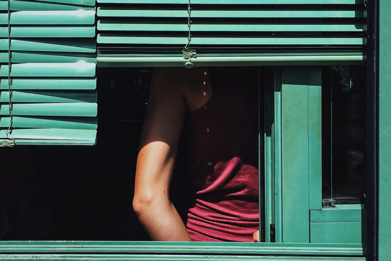 Woman Behind Shutters