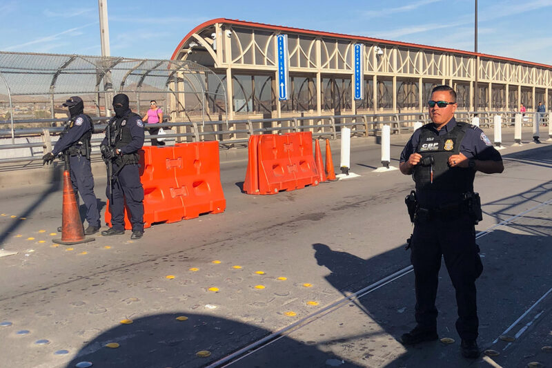 Border patrol officers on a bridge