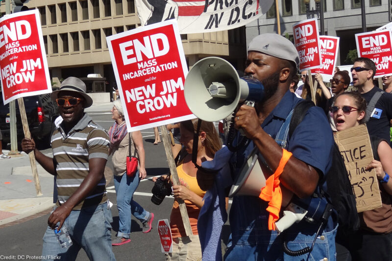 Demonstrators carry signs advocating an end to mass incarceration