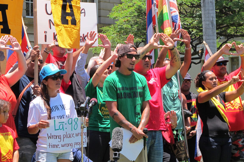 Protesters hold their hands in the shape of a mountain to symbolize protecting Maunakea during a news conference on their efforts to block the construction of the Thirty Meter Telescope