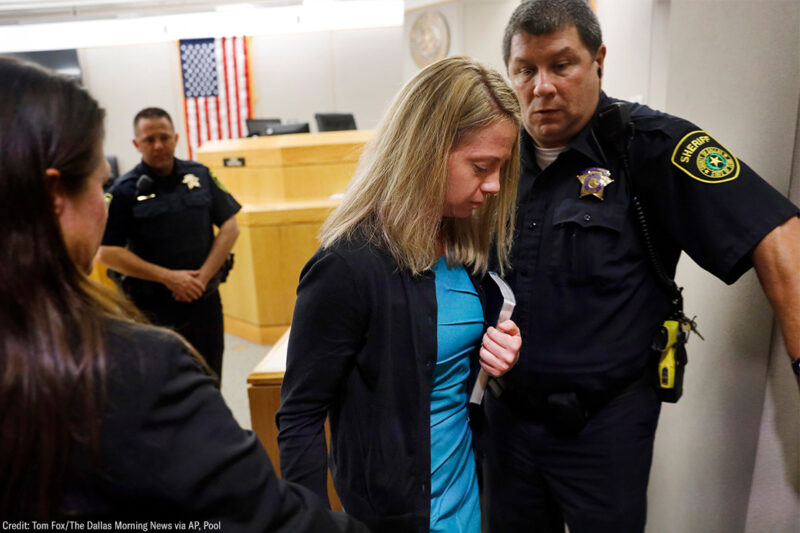 Holding a Bible given to her by State District Judge Tammy Kent, former Dallas Police Officer Amber Guyger leaves court for jail following her sentencing