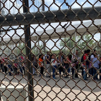 Families at the border through fence