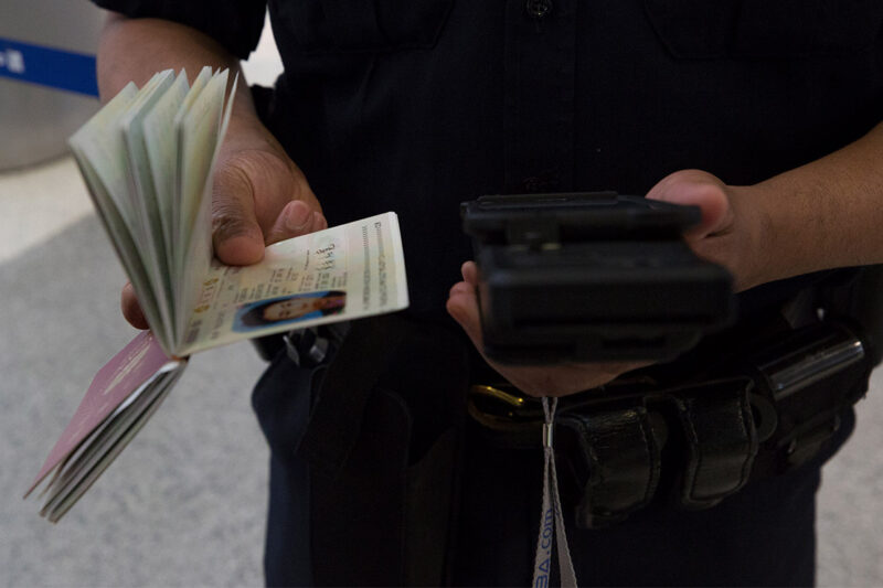 A CBP officer scanning a passport