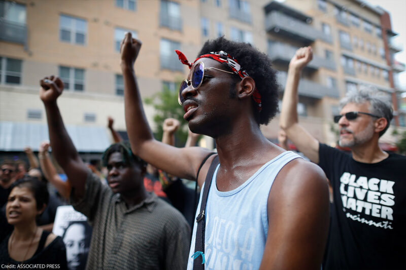 Demonstrators with fists raised in solidarity.