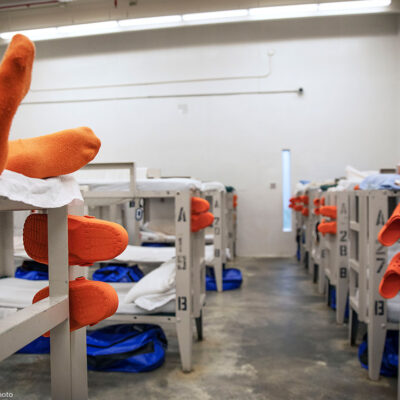 A detainee lays on a bunk in a pod at the Stewart Detention Center in Lumpkin, Ga. As of November 2019, 1,625 male detainees were said to be held at the center by ICE.