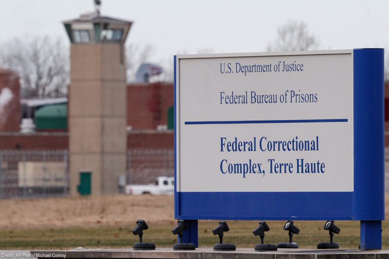 A guard tower flanks the sign at the entrance to the U.S. Penitentiary in Terre Haute.