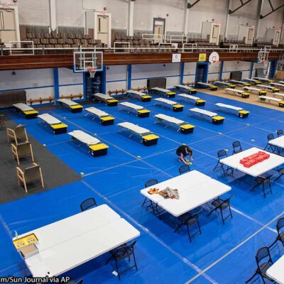 Community Concepts Wellness Shelter Attendant, marks the start of the meal line at the Lewiston Armory, in Lewiston, Maine on Wednesday, April 22, 2020.