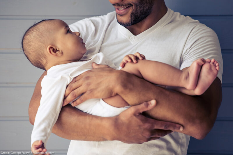 A parent cradling an infant.