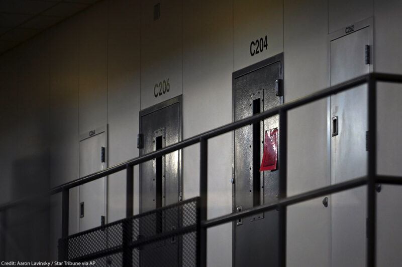 A red tag hangs on a cell door, signifying an active COVID-19 case for its inhabitants in the Minnesota prison.