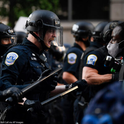 Police in riot gear shouts in black protestor's face as demonstrators gather to protest the death of George Floyd near the White House