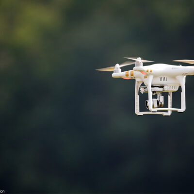 A civilian UAV, or drone, flying outdoors.