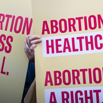 Protest signs advocating for abortion access.