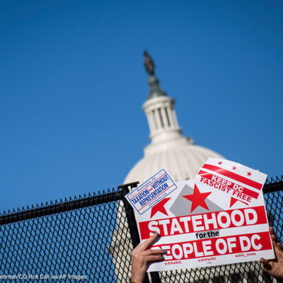 A demonstrator holds up a sign advocating for statehood for Washington, D.C.