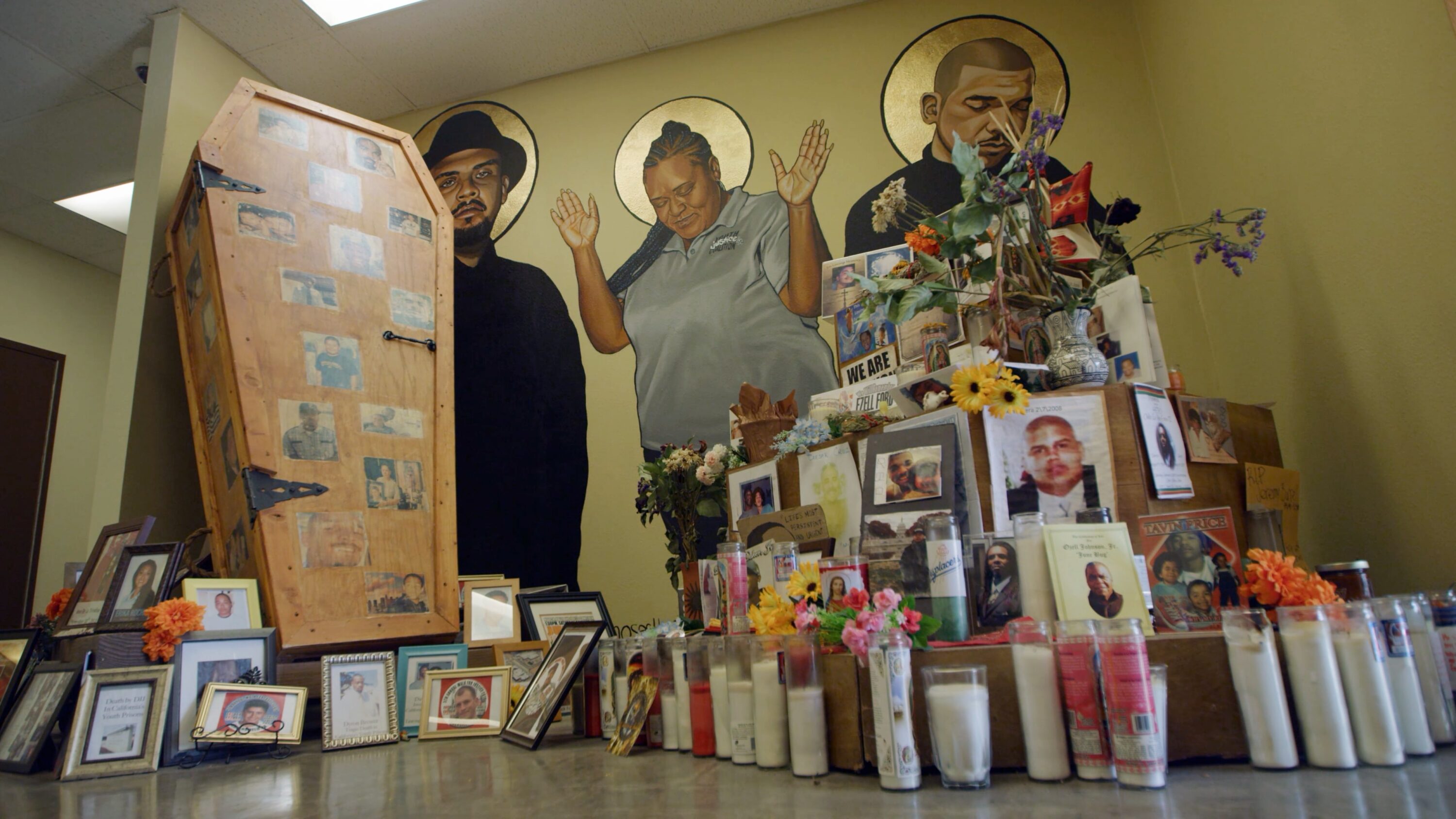 Image from interview showing votive candles and wall murals