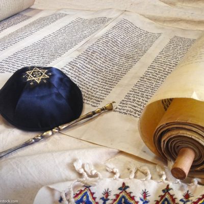 The Hebrew handwritten Torah, on a synagogue alter, with Kippah and Talith