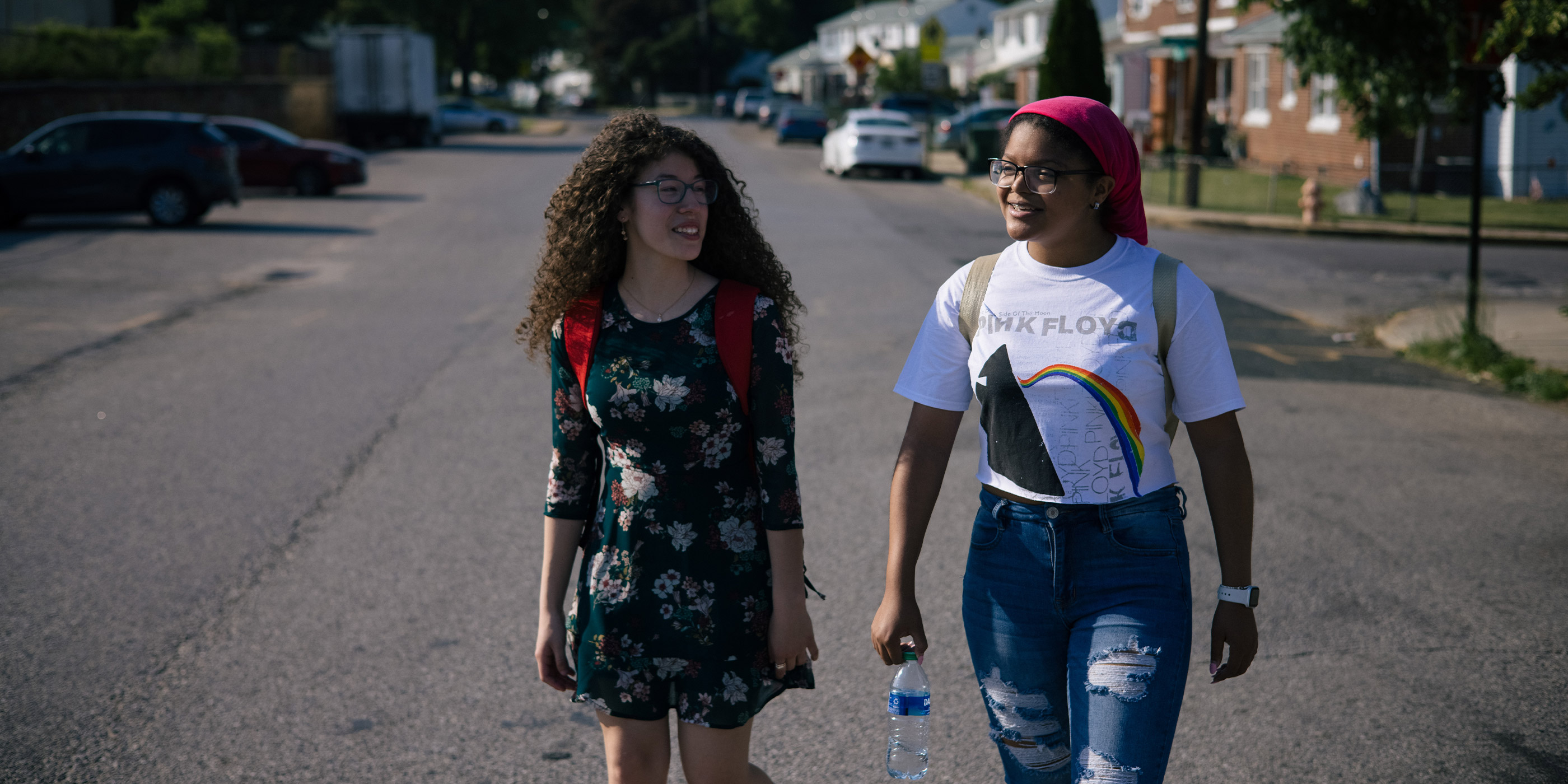 Two girls, Kimberly and Yashira, walking in the middle of the street