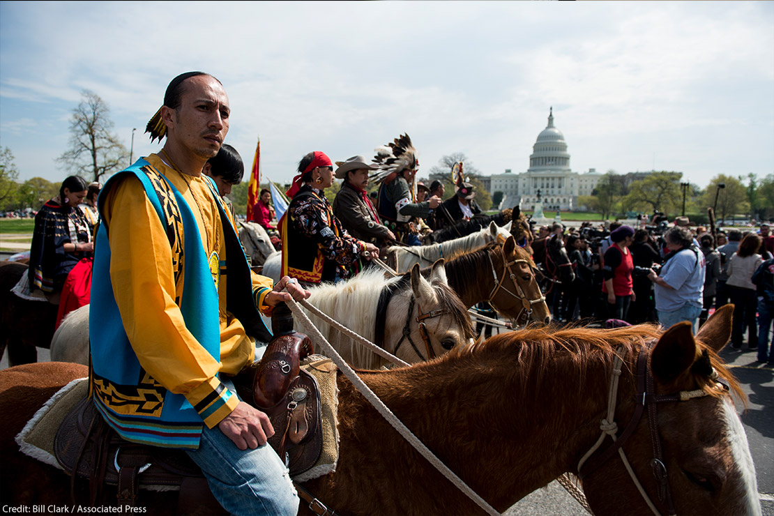 Native Americans on horse back protesting at Capitol Hill