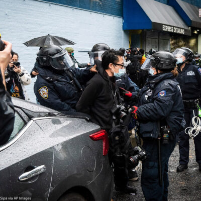 A photojournalist is arrested by NYPD officers during an anti-Trump protest in New York City