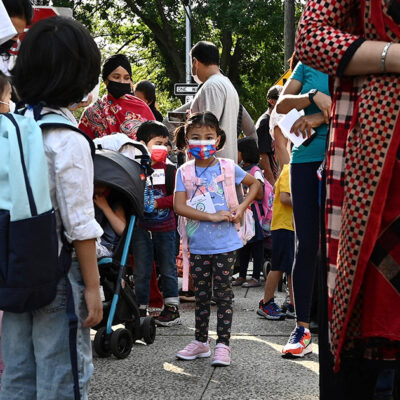 Families line up to drop off their children for in-person learning as New York City Public Schools reopen.