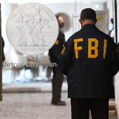 An FBI employee guards the entrance doors to the Detroit City Council on the 13th floor of the Coleman A. Young Municipal Center, Thursday, Aug. 25, 2021, in Detroit.