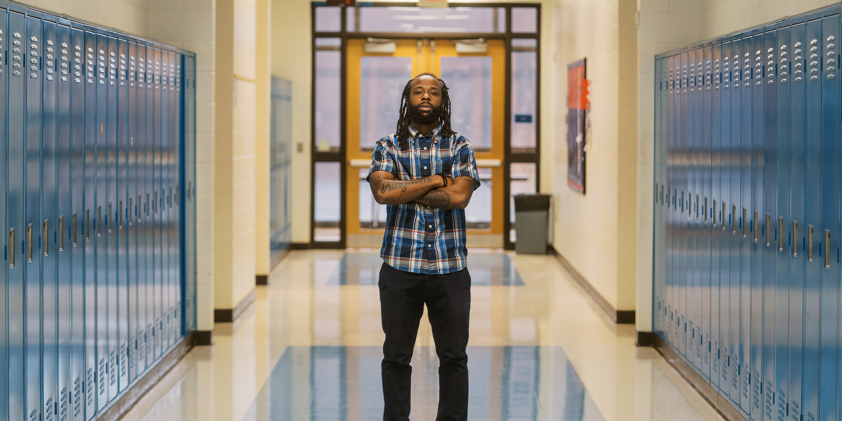 Anthony, a teacher profiled in this blog, stands in the middle of his school's hallway