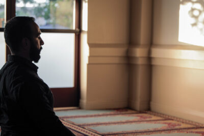 Ali Malik praying in a mosque