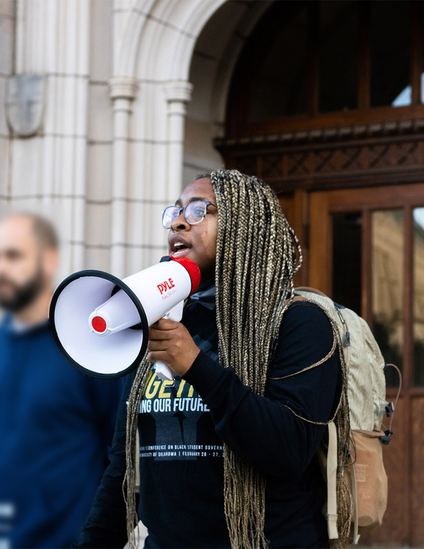 Lilly using a bullhorn at a protest