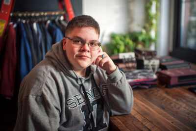 A portrait of Gavin Grimm at a desk.