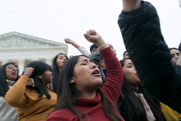 a crowd of people with fists in the air