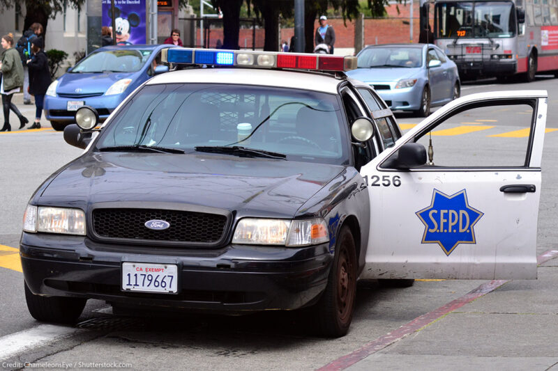 Modern SFPD police car cruiser with the door on the driver side open.