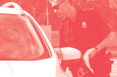 A police officers checking a vehicle.