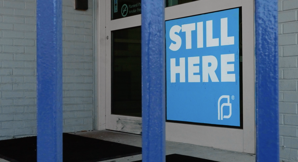 A Planned Parenthood sign reading, "Still Here."