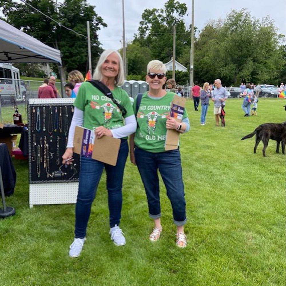 Connie Horton-Kross (right) and friend stop for a picture while canvassing in a park.