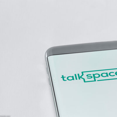 Image of Talkspace app on a smartphone on a white background.